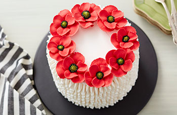 White buttercream cake with red buttercream poppies