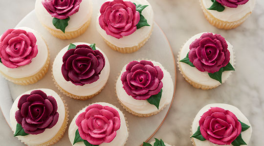 The Wilton Rose piped on ice cream cone cupcakes